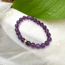 Charger l'image dans la galerie, Amethyst Bracelet close-up on white cloth – purple bead detail shot