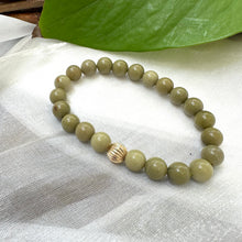 Load image into Gallery viewer, Green Olivine Jasper Bracelet displayed on white cloth – detailed close-up