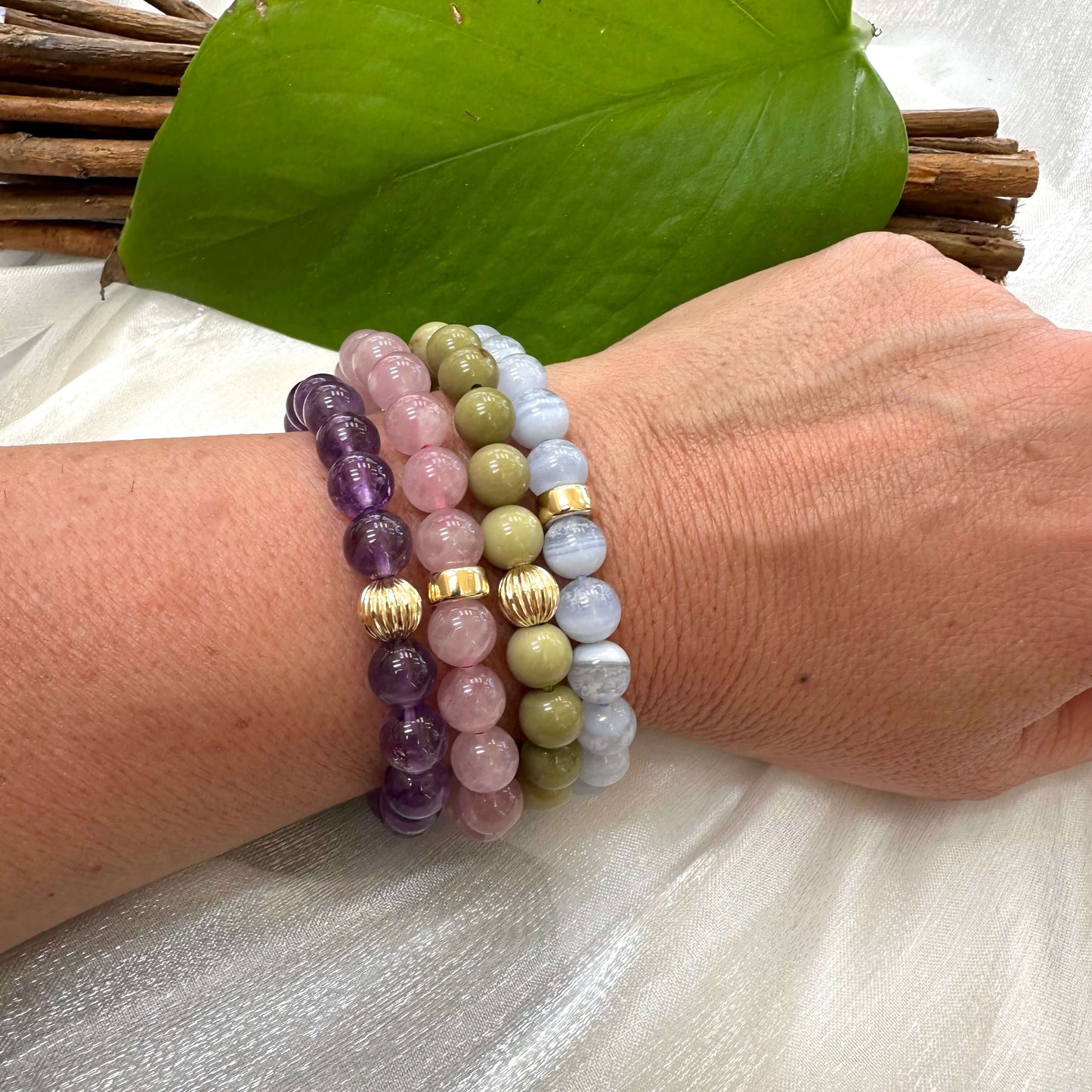 Amethyst Bracelet worn with mixed gemstone bracelets on woman’s wrist – stacked look