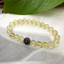 Load image into Gallery viewer, Lemon Quartz Bracelet close-up on white cloth – bright yellow gemstone beads