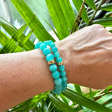 Load image into Gallery viewer, Blue Amazonite Bracelet worn on model’s wrist against foliage – lifestyle close-up