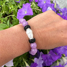 Load image into Gallery viewer, Lavender jade bracelet with pearl worn on a woman’s wrist beside flowers