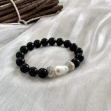 Load image into Gallery viewer, Black onyx bracelet with pearl displayed on white cloth