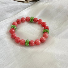 Load image into Gallery viewer, Red jade bracelet without pearl and green rhinestones displayed on white cloth