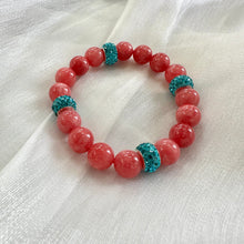 Load image into Gallery viewer, Red jade bracelet without pearl and blue rhinestones displayed on white cloth