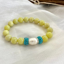 Load image into Gallery viewer, Olive green jade bracelet with one pearl displayed on white cloth