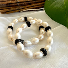 Load image into Gallery viewer, White pearl stretch bracelet with black rhinestones displayed on white cloth