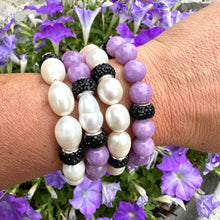 Load image into Gallery viewer, White pearl stretch bracelet with black rhinestones worn on woman's wrist stacked with similar bracelet