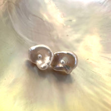 Charger l'image dans la galerie, Handmade white flower pearl stud earrings on pearl shell, showing natural irregular shape and elegant gold vermeil posts.