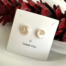 Charger l'image dans la galerie, White flower pearl stud earrings in gift box beside red pine cone, showing festive packaging and romantic handmade design.