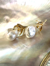Charger l'image dans la galerie, Close-up of handcrafted Baroque Pearl Earrings with oak leaf gold vermeil design displayed on white pearl shell background.