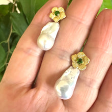 Charger l'image dans la galerie, Handmade chrome diopside pearl earrings with removable baroque drops, shown in hand against green leaf