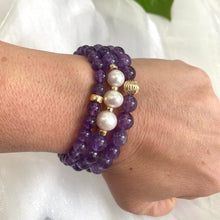 Charger l'image dans la galerie, Two amethyst bracelets worn with an amethyst and pearl bracelet on wrist