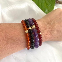 Charger l'image dans la galerie, Amethyst bracelet worn on wrist with multiple stacked gemstone bracelets