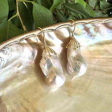 Charger l'image dans la galerie, Close-up of freshwater baroque pearl earrings showing iridescent pink green hues on pearl shell surface
