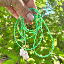 Charger l'image dans la galerie, Apple Green Chrysoprase Lariat Necklace held against green leaves — natural gemstone and pearl lariat handcrafted by Loulia Pearl Jewelry