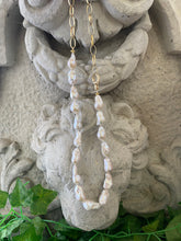 Charger l'image dans la galerie, White baroque pearl and gold chain necklace draped from cement statue, modern asymmetric handmade necklace from Canada.