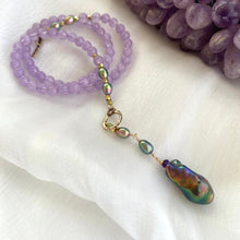 Charger l'image dans la galerie, Amethyst Pearl Necklace displayed on white background beside raw amethyst gemstone.