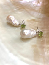 Charger l'image dans la galerie, Baroque pearl drop earrings with peridot studs on white pearl shell backdrop