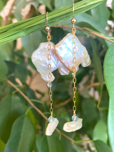 Charger l'image dans la galerie, Close-up of boho pearl earrings gold filled photographed with green leaves — natural light jewelry shot showing blue topaz accent stones