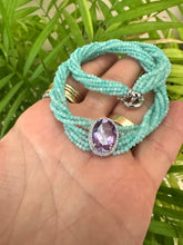Charger l'image dans la galerie, Amethyst Amazonite Choker Necklace – 8-Strand Twisted Gemstone Collar displayed on a hand with green foliage.