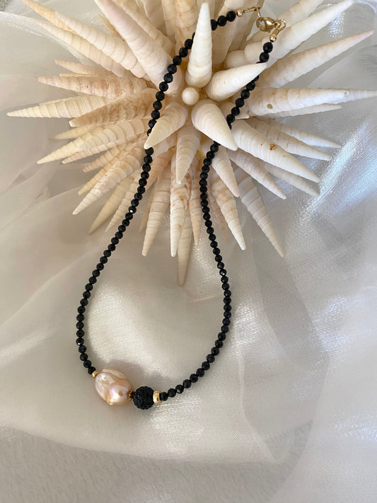 Black spinel pearl necklace displayed on white cloth