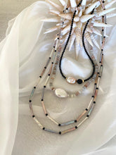 Charger l'image dans la galerie, Moonstone and Baroque Pearl Necklace displayed on soft fabric with seashell decor.