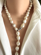 Load image into Gallery viewer, Edison Pearl necklace worn by a person in a white outfit. pearls are baoque and hand knotted