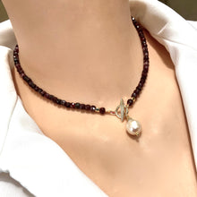 Load image into Gallery viewer, Garnet toggle necklace with baroque pearl charm, showcasing deep red garnet beads and elegant craftsmanship.
