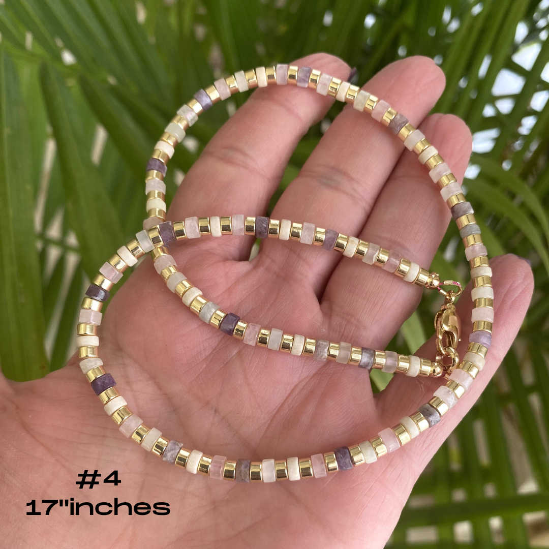 Gemstone choker necklace with multi color beads and hematite displayed on hand, measuring 17 inches.