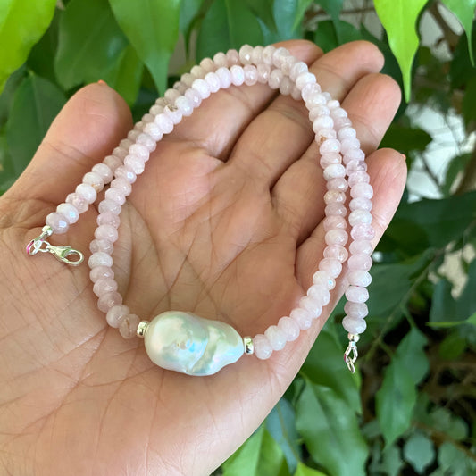 Rose quartz pearl necklace held in hand with faceted rose quartz beads and large baroque pearl, handmade Canadian jewelry