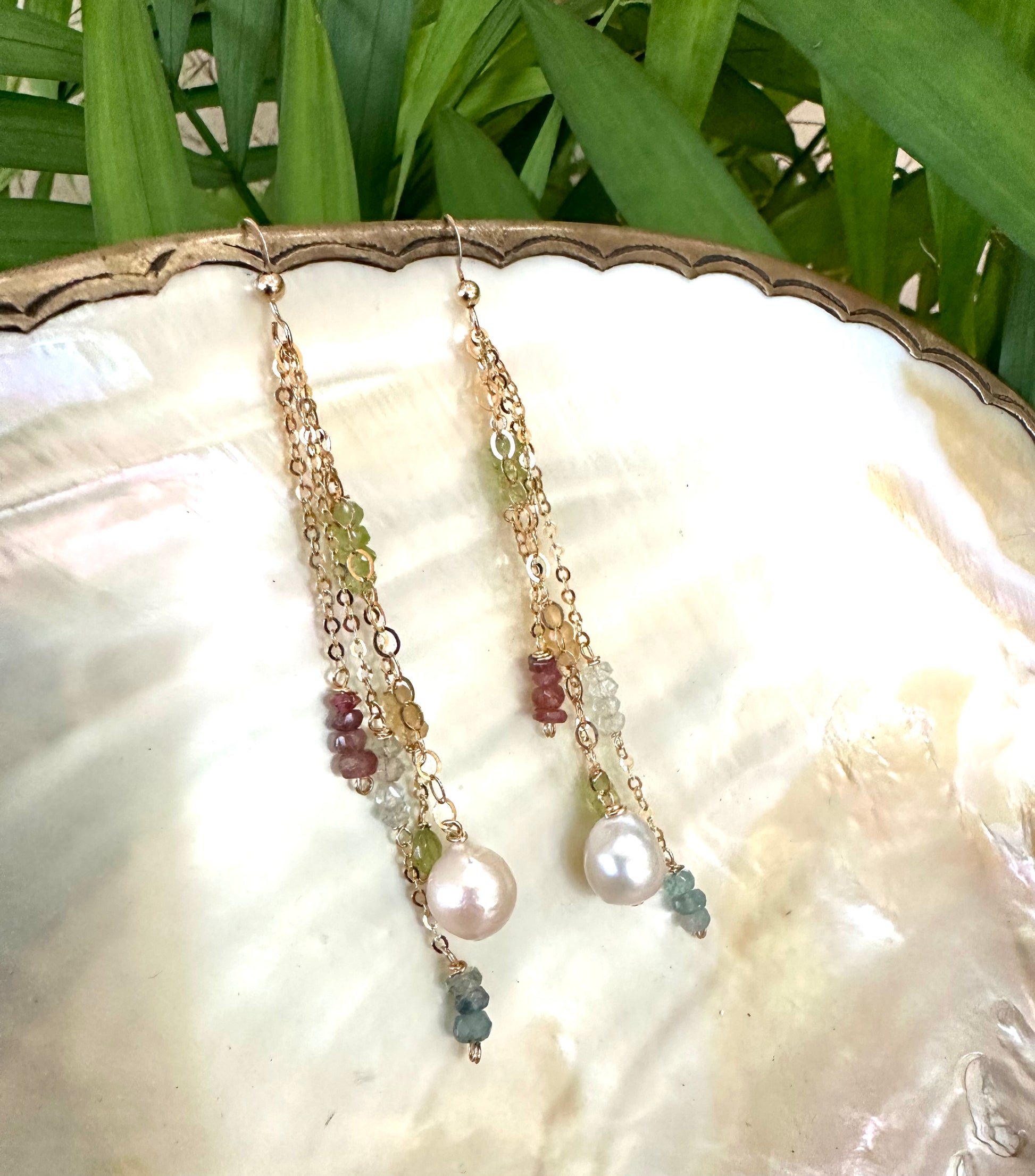 Baroque pearl gemstone earrings displayed together with pastel natural gemstones