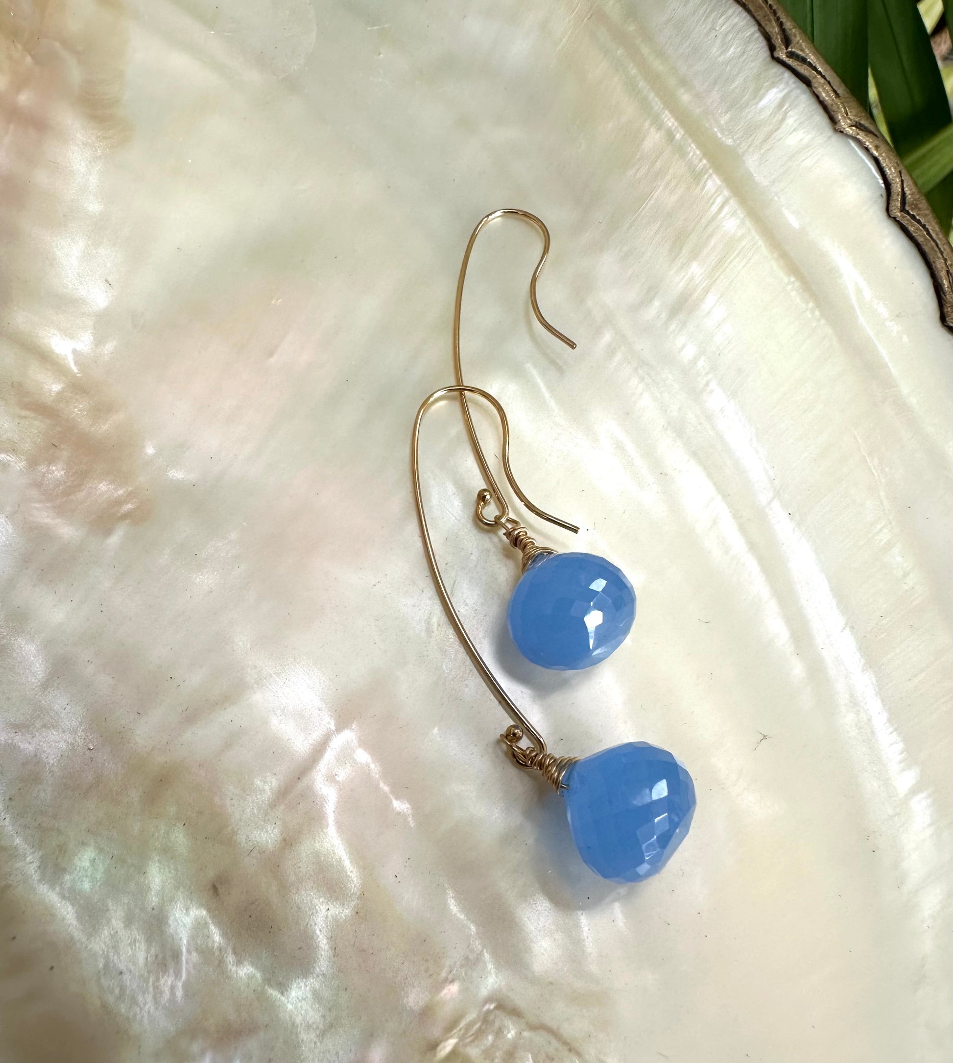Chalcedony threader earrings with blue briolettes showcasing elegant design and translucent blue tones.
