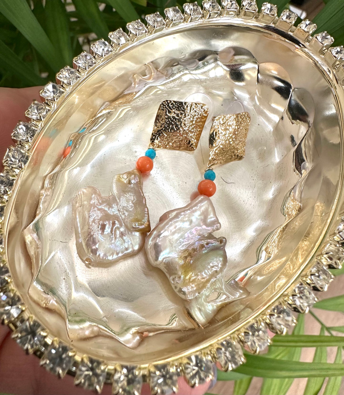 Baroque Pearl Turquoise Coral Earrings displayed in a shiny decorative bowl, showcasing their chunky gold design.