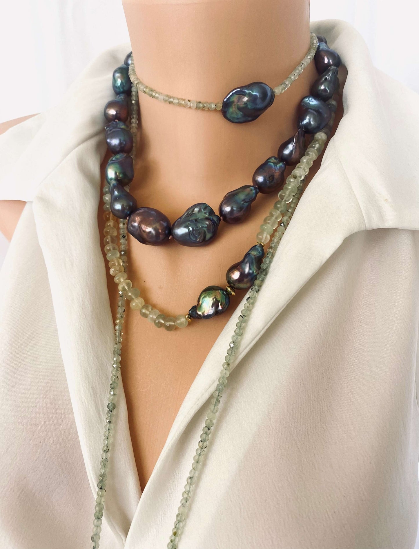 Black Baroque Pearl Necklace | Handcrafted Chunky Design showcasing unique peacock-black pearls on dark-pink silk.