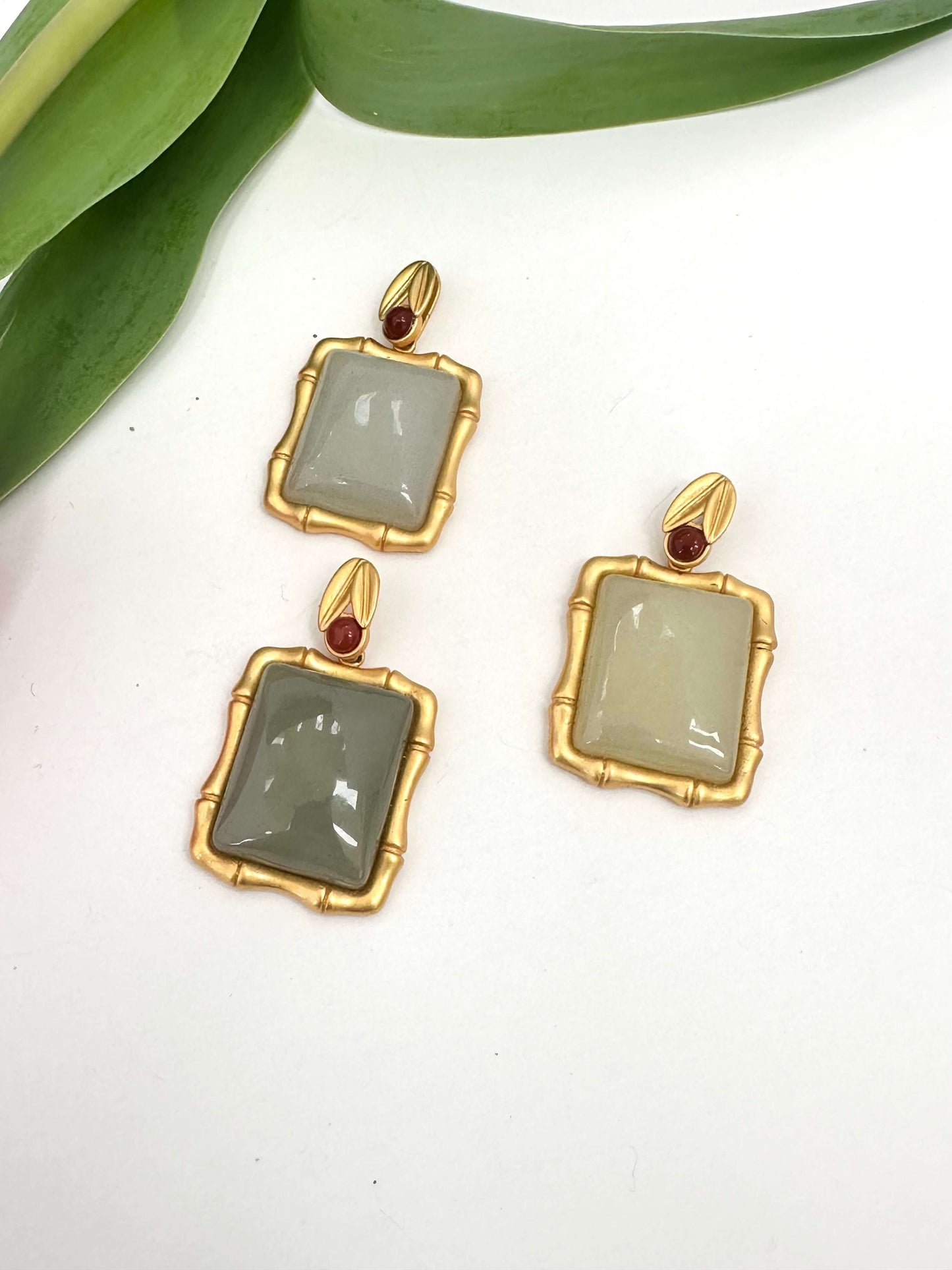 Bamboo style jade pendant with red agate in gold vermeil, featuring unique jade stones in soft hues.