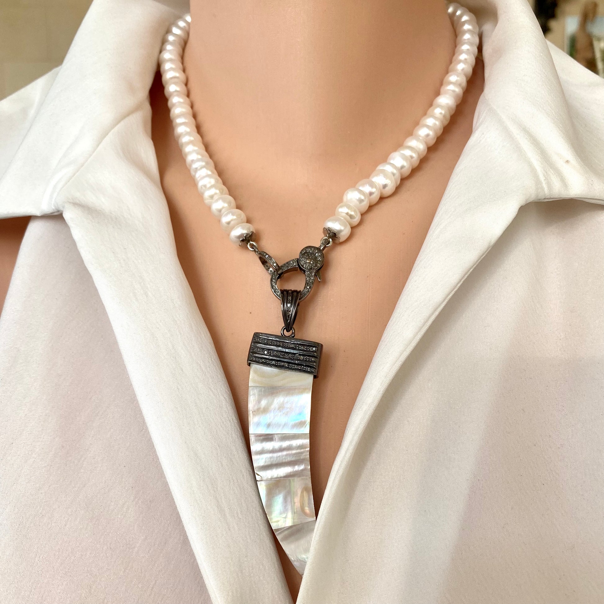 Button pearl necklace with diamond pavé styled with a removable pendant on oxidized silver clasp
