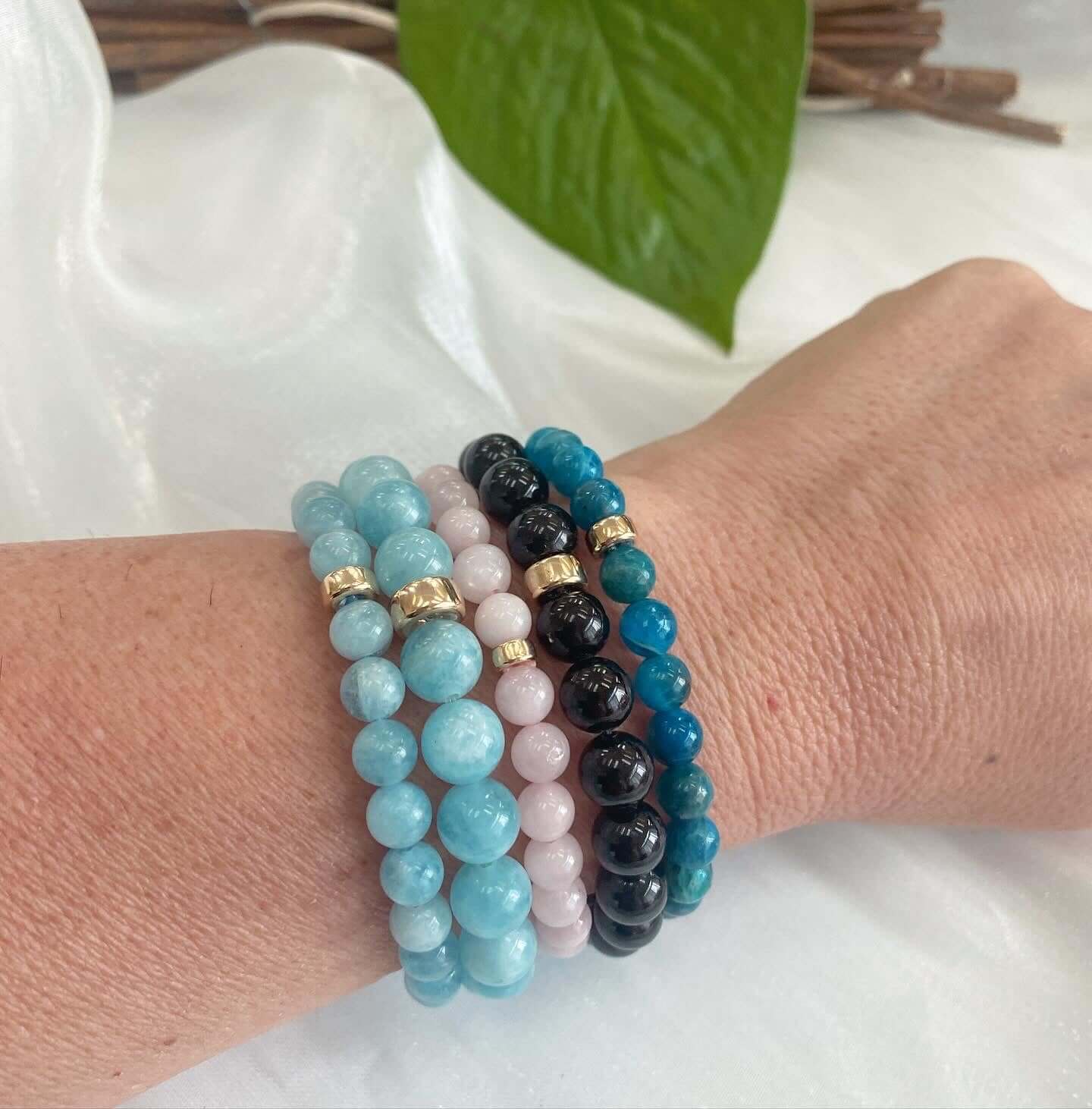 Blue Apatite Bracelet paired with gold and gemstone bracelets – lifestyle close-up