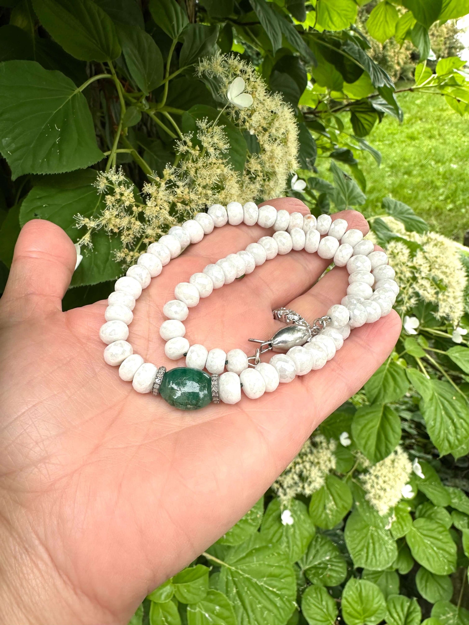 Emerald diamond choker necklace featuring white silverite beads emerald centerpiece and diamonds