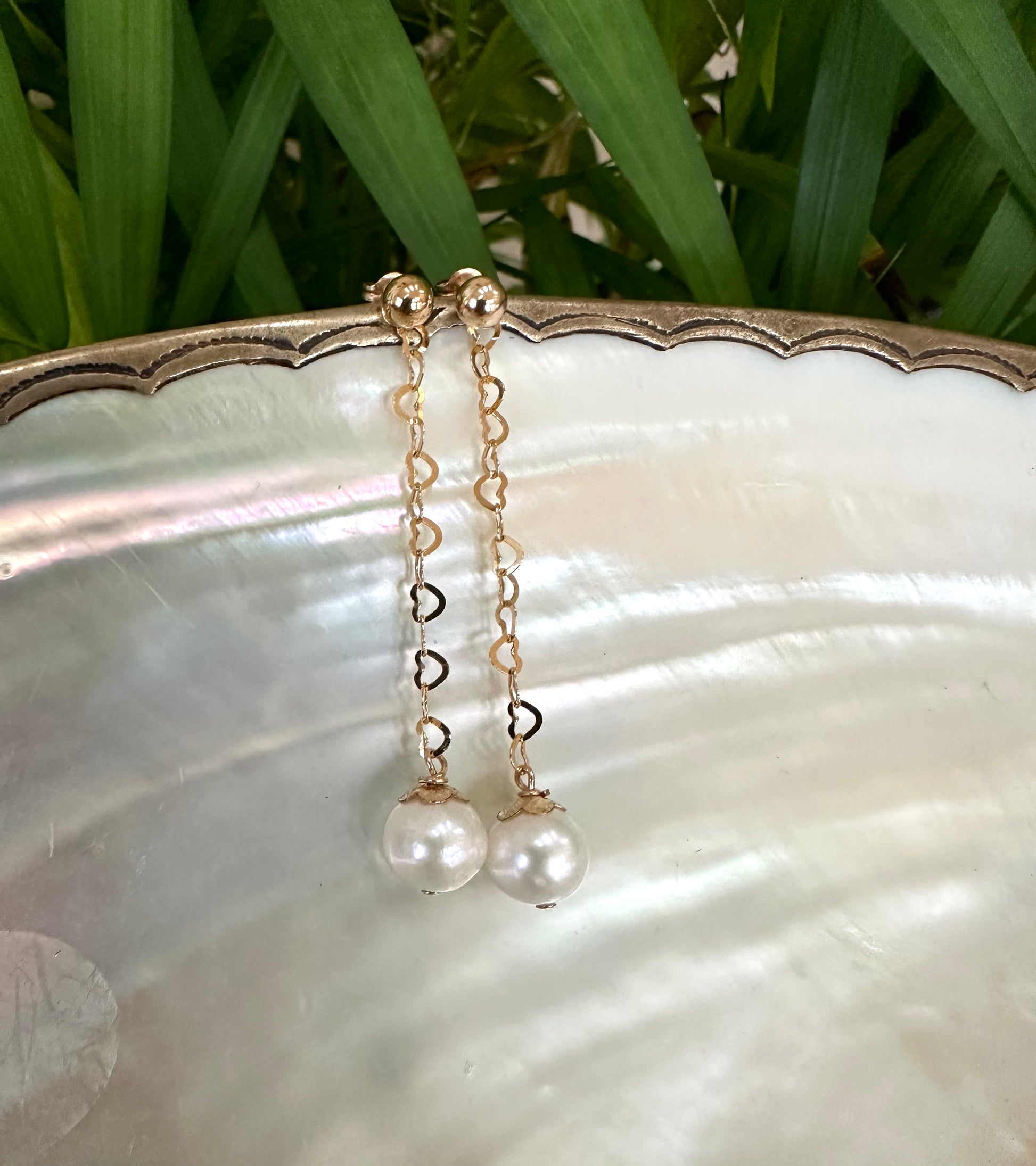 Pearl heart drop earrings close up showing gold filled heart chain and pearl drop