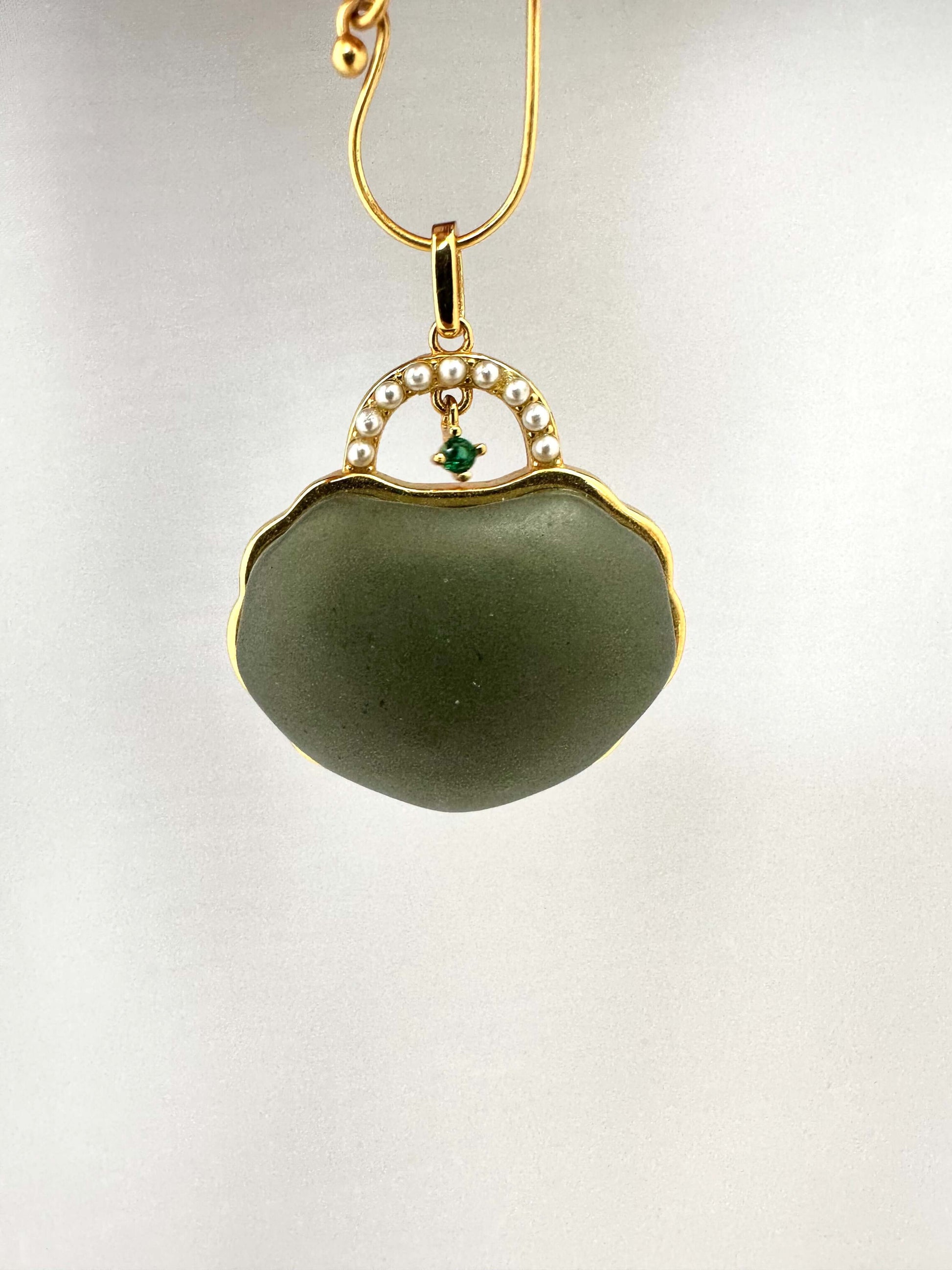 Hotan jade purse pendant with pearl detail in gold vermeil, showcasing a miniature purse design with a calming green tone.