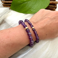 Amethyst Bracelet pair worn on woman’s wrist – natural lifestyle shot
