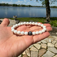 White Tridacna Bracelet held in hand in natural light – outdoor close-up