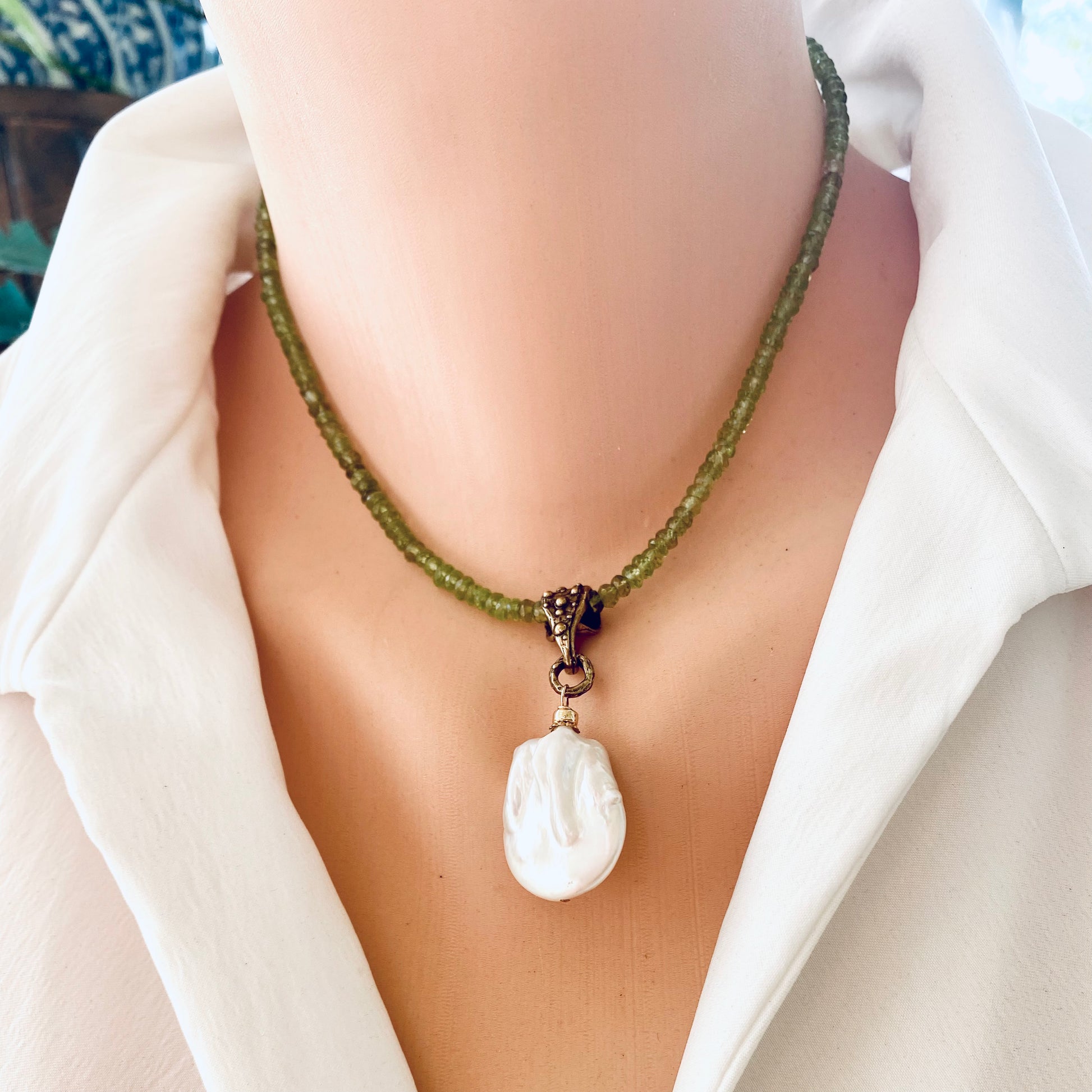 Peridot pearl pendant necklace worn at the neckline with artisan gold bronze bail and baroque pearl