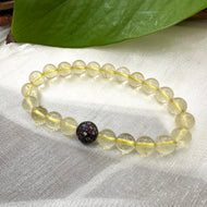 Lemon Quartz Bracelet close-up on white cloth – bright yellow gemstone beads