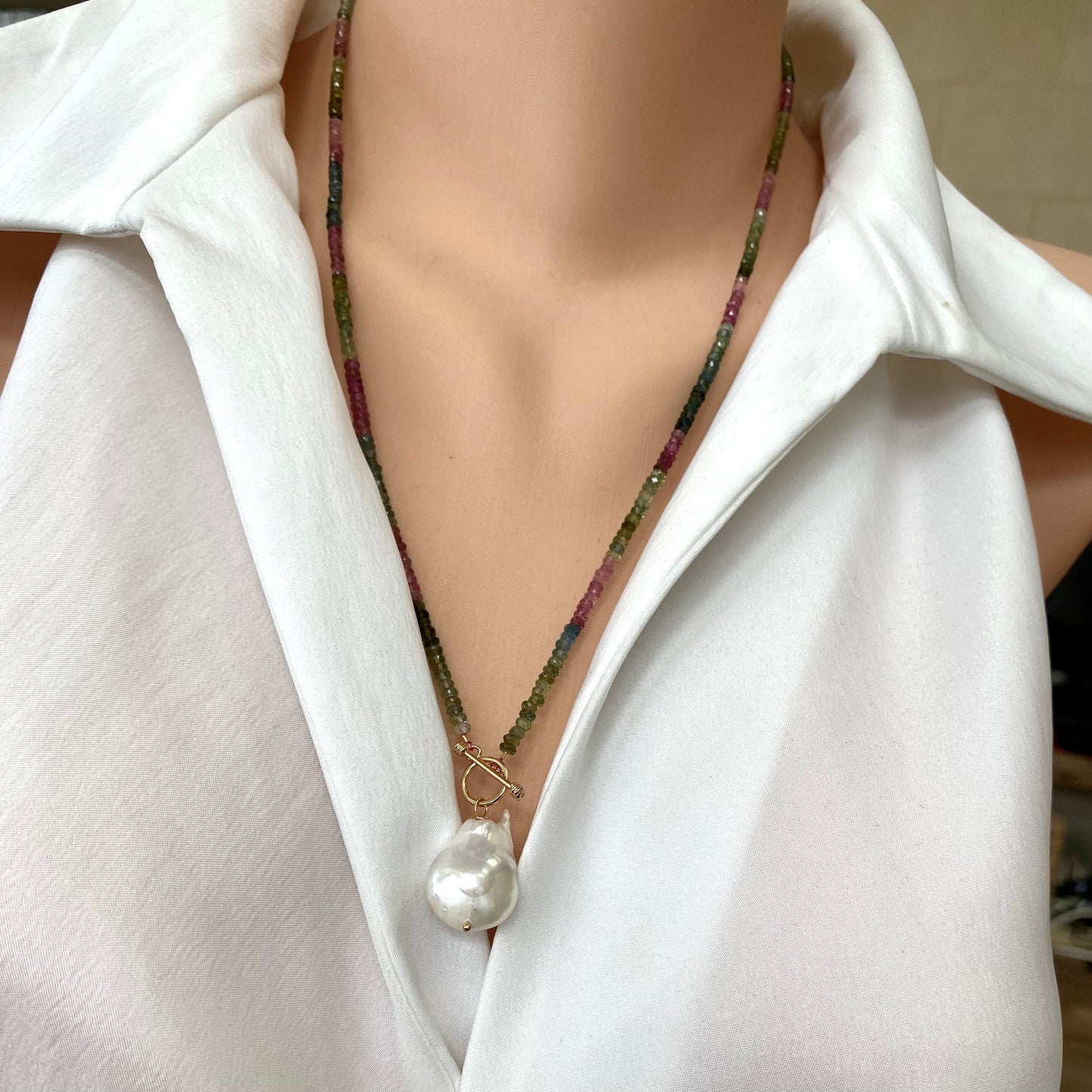 Tourmaline baroque pearl toggle necklace styled at the collarbone with natural baroque pearl