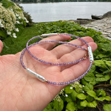 Charger l&#39;image dans la galerie, Amethyst Pearl Necklace held in hand against summer foliage – outdoor detail shot
