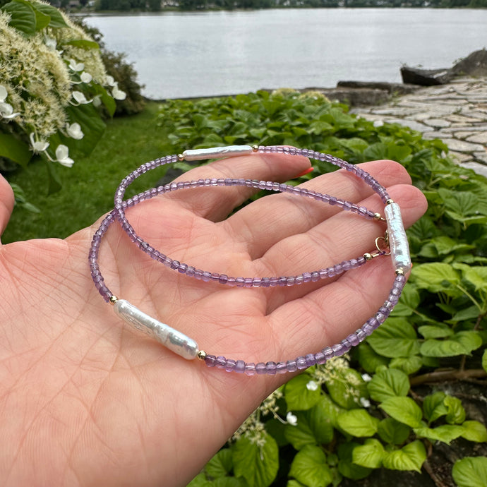 Amethyst Pearl Necklace held in hand against summer foliage – outdoor detail shot