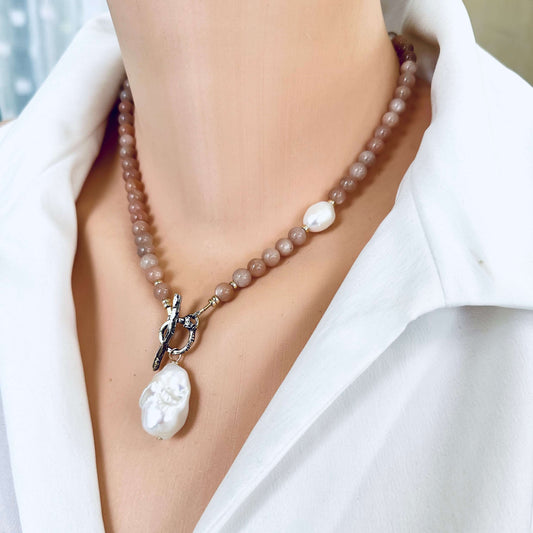 Side close-up of sunstone necklace with baroque pearl pendant worn on mannequin