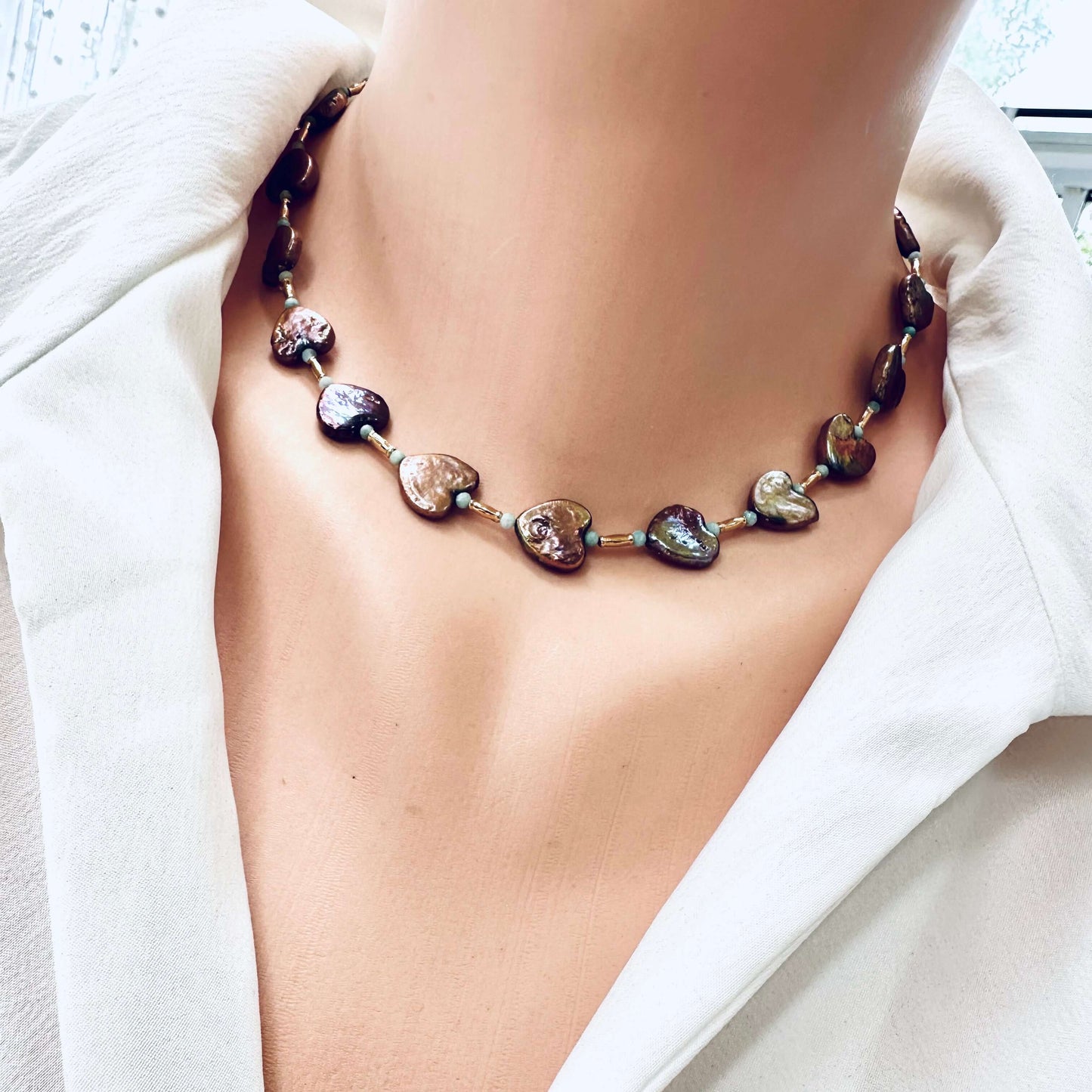 Side close-up of bronze pearl choker with amazonite beads worn on mannequin